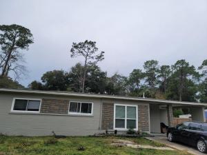 a house with a car parked in front of it at Great large home,8 min from Downtown in Pensacola