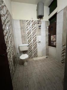 a bathroom with a toilet and a shower at Hotel Skylark in Amritsar