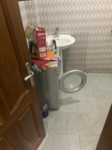 a bathroom with a toilet and a sink at La Teranga Lebou in Dakar