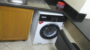 a washing machine in a kitchen next to a counter at Ruby Star Male Hostel Dubai in Dubai
