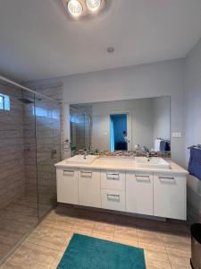 a large bathroom with a sink and a shower at Modern Luxury with Nature in Camden