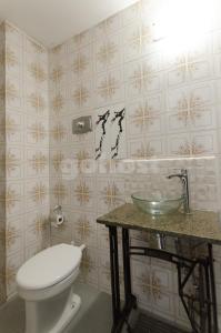 a bathroom with a toilet and a sink at Spacious Apartment Located In Downtonwn Asuncin in Asunción