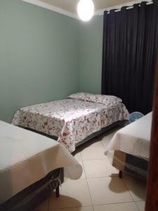 a room with two beds in a room at apart hotel big john 102 in Divinópolis