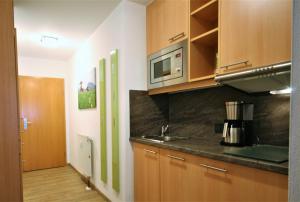 a kitchen with a sink and a microwave at Ferienwohnung Vera in Schwangau