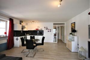 a kitchen and living room with a table and chairs at Ferienwohnung Stephan in Füssen