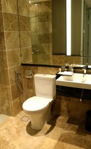 a bathroom with a toilet and a sink at Estadia Hotel in Malacca