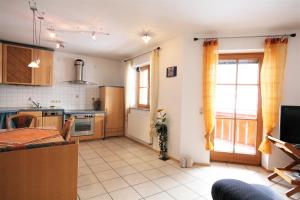 a kitchen with a dining table and a kitchen with at Ferienwohnung Romi in Pfronten