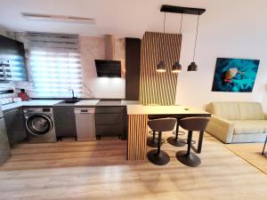 a kitchen and living room with a table and chairs at Alcaidesa, luxury apartment with sea views in Alcaidesa