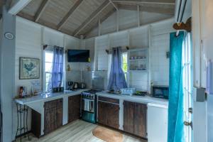 a kitchen with a stove and a counter top at The Ti-Kaye Oasis in Crab Hill