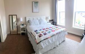 a bedroom with a large bed and a mirror at Market Place Living in Stratford