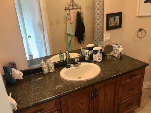 a bathroom counter with a sink and a mirror at Market Place Living in Stratford
