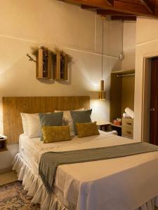 a bedroom with a large bed with two pillows at Selva María Hotel Boutique in Santa Fe de Antioquia