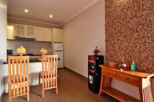 een keuken met 2 stoelen, een tafel en een koelkast bij Ubud City 2BR Private Pool Villa in Ubud in Ubud