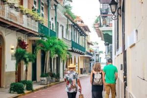 a group of people walking down a street at Comfy Love Nest w/ Private Pacific View in Panama City