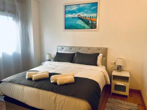 a bedroom with a bed with two pillows on it at Luxe Forum Beach Terrace in Sant Adria de Besos