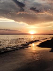 a sunset on a beach with the ocean at Fogón y mates- portezuelo in Maldonado
