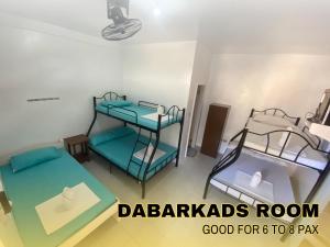 a room with two bunk beds in a room at Medelaine's Beach Resort in Puerto Galera +5 photos