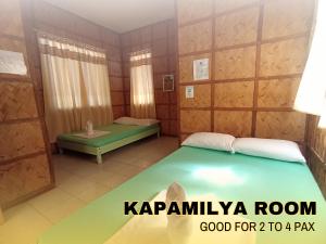 a small room with a bed and a table at Medelaine's Beach Resort in Puerto Galera