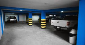 a parking garage with cars parked in it at Gran Hotel Canada in Santa Cruz de la Sierra