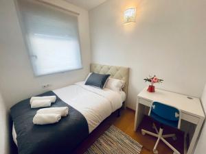a small bedroom with a bed and a desk at Luxe Forum Beach Terrace in Sant Adria de Besos