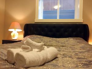 a bed with towels on it with a window at JESI'S NEW HOUSE, Self Enter 2BR, Whole Suite, Close to White Rock Beach & US Border in Surrey
