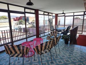 a balcony with a table and chairs and a view at Lidia Anturios in Oaxaca City