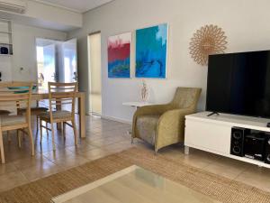a living room with a television and a dining room at Mariner Resort Comfort - unit 165 in Geraldton
