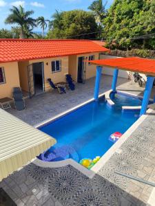 a pool in front of a house at Villa Bellevue in San Felipe de Puerto Plata
