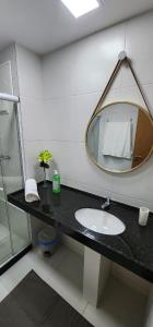 a bathroom with a sink and a mirror at Mana Beach Experience - Porto de Galinhas - Muro Alto Alto in Ipojuca
