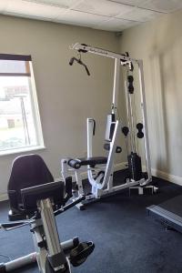 a gym with a treadmill and a chair in a room at SAMIR Stay at NW Expressway in Oklahoma City