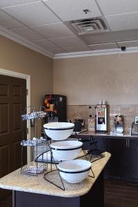 a kitchen with three white bowls on a counter at SAMIR Stay at NW Expressway in Oklahoma City