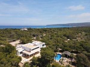 an aerial view of a large white house with a pool at Villa Leonor in Es Calo