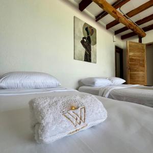 Postel nebo postele na pokoji v ubytování Cabañas W Beach