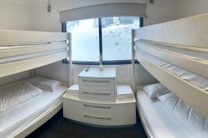 a room with two bunk beds and a window at Lawlers 42 in Mount Hotham