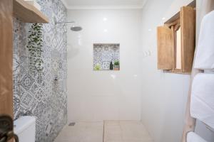 La salle de bains est pourvue d'une douche et de toilettes. dans l'établissement Angel House Ubud Eco Villa, à Ubud