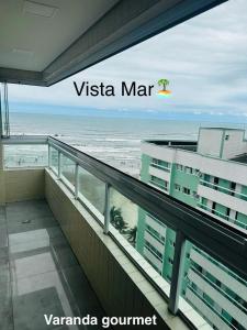 a view of the ocean from the balcony of a building at APTO BEIRA MAR - ACONCHEGANTE _ VARANDA GOURMET - WIFI - NETFLIX - TV A CABO - PRAIA GRANDE in Praia Grande