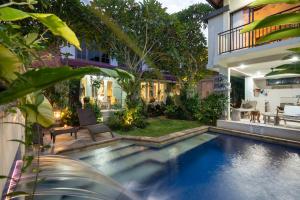a swimming pool in a yard with a house at Angel House Ubud Eco Villa in Ubud