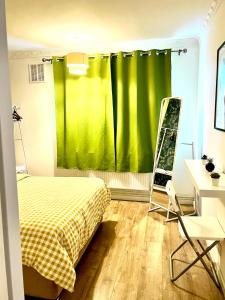 a bedroom with a bed and a green curtain at Private double room in the center of london in London