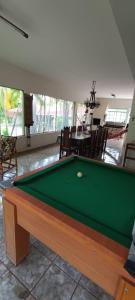 a pool table in the middle of a living room at Chácara Pingo de Ouro in Salto Grande
