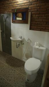 a bathroom with a toilet and a sink at Omah Dekso 