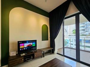 a living room with a tv and a large window at Bay Laurel @ Country Garden, Danga Bay, Johor Bahru, Johor in Johor Bahru