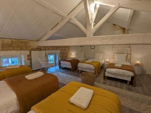 a bedroom with four beds in a room at Maison spacieuse avec terrasse, proche CNDBI, idéale pour familles et événements, animaux acceptés. - FR-1-653-249 in Saint-Yrieix-sur-Charente