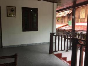 an empty room with a door and a stair case at Duang Champa 2 Guest house in Luang Prabang