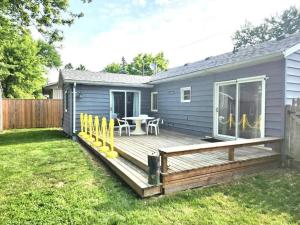 a deck with a table and chairs on a house at Bluewater Delight in Sarnia