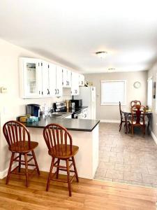 a kitchen with wooden chairs and a counter top at Bluewater Delight in Sarnia
