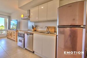 a kitchen with a large stainless steel refrigerator at Appartement 2 chambres Blue Marine Maho Sxm in Maho Reef