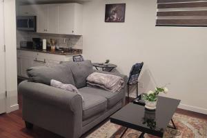 a living room with a couch and a table at Two luxury bedrooms in the basement in Winnipeg