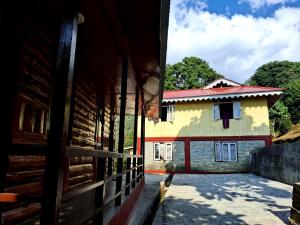 a house with a fence in front of it at Zen homestay in Ravangla