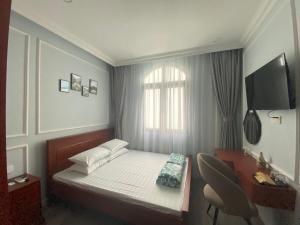 a small bedroom with a bed and a window at UY LONG Homestay Grand World Phú Quốc in Phú Quốc