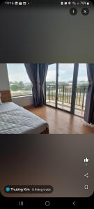 1 dormitorio con cama y ventana grande en Khách sạn AN THỊNH 2, en Doc Let